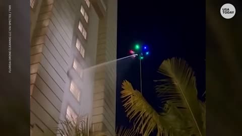 Colorful UFO-like drone cleans windows outside high-rise hotel | USA TODAY