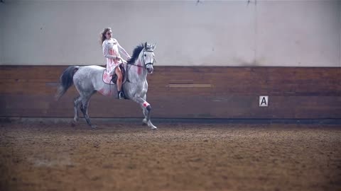 Bloody Princess Riding White Horse. Horse Riding Masquerade Competition in Big Riding Hall