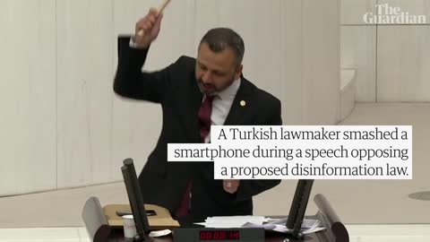 Turkish lawmaker smashes phone with hammer during speech