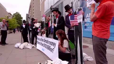 'Debt collector' protesters demonstrate outside IMF