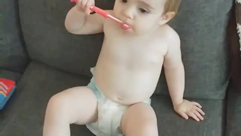 Baby girl loves her new toothbrush