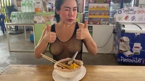 Lady chef cooking the most popular pork noodles - Thai street food