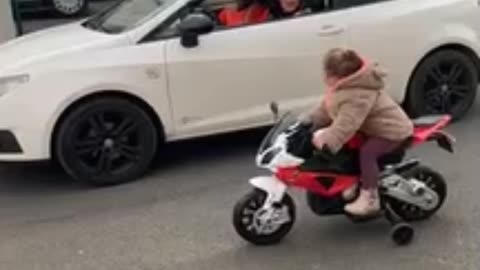 Kid on Toy Motorbike Challenges Driver to a Race || ViralNEWS