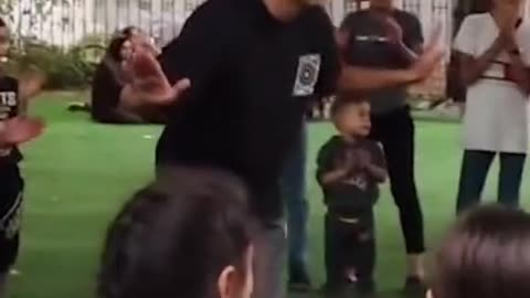 Palestinian artist Mohammed Sami playing with Children less than a day before he was killed in Gaza