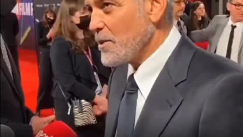 Actor George Clooney being paid to read lines and be a useful idiot