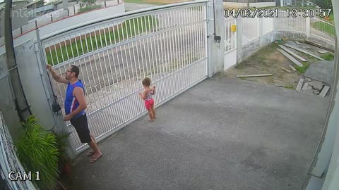 Girl Hangs on While Dad Opens Gate