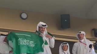 Qatar Emir Tamim bin Hamad Al Thani donning a Saudi flag at the start of the Saudi Arabia-Argentina