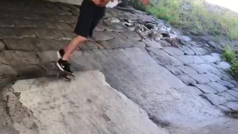 Shirtless man black shorts failed skateboard trick