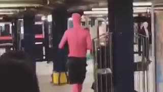 Man in all pink body suit and black shorts