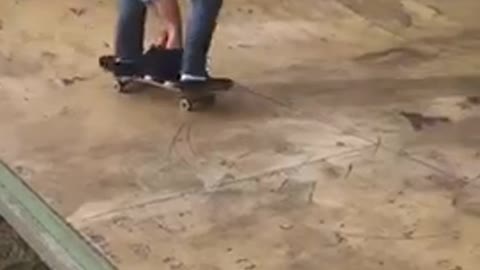 Guy skateboards with toddler holding unto him