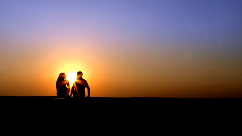 A couple romance and talk at sunset