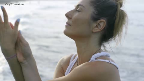 A Woman Doing Meditation And Stretching Exercise By The Beach | Lucy07