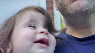 Baby amused by drinking dad