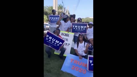 A group of black Trump supporters gather together and chant "Trump train don't stop!"