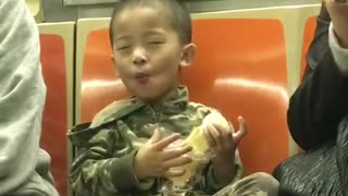 Little boy subway army outfit enjoying food