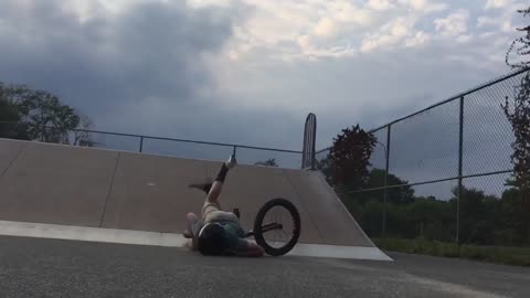 Kid in skatepark slow mo bike face plant