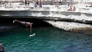 Dog And Owner Simultaneously Perform Cliff Dive