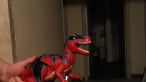 PUPPIES PLAYING WITH DINOSAUR TOY