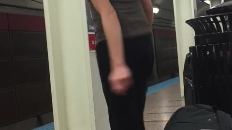 Guy blonde short hair grey tank top dancing subway platform