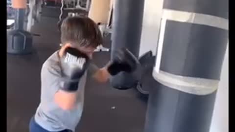 How to punch a boxing bag by a 7 year old boy