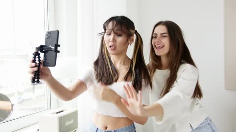Girls Dancing while Using Smartphone