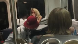 Two people arm wrestle in subway