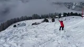 Woman red jacket ski stuck flips