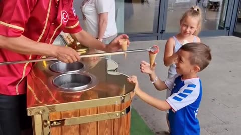 Ice Cream Vendor Plays Game With Young Customer