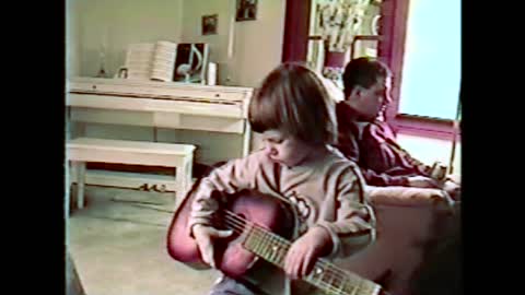 Little Guitarist Tries To Tune Her Guitar, Ends Up Hitting Mom In The Face