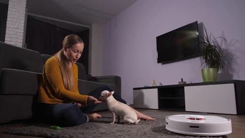 Robotic vacuum cleaner doing housework while happy
