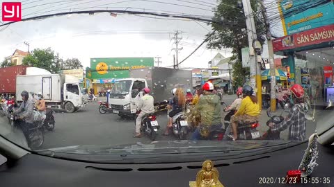 Truck Stops on Top of Motorcycle in Busy Intersection