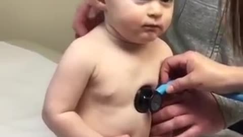 Sweet baby boy rests head on nurse' hand