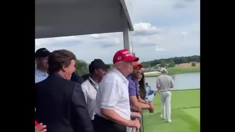 Trump & Tucker Carlson look on as crowd shouts “Let’s go Brandon”