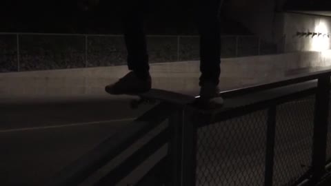 Guy puts skateboard on rail falls to side