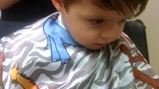 Toddler struggles to stay awake during haircut