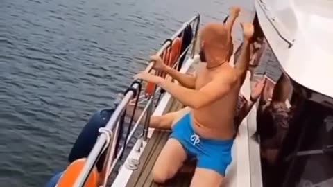 dude goes to jump off boat but slips instead.