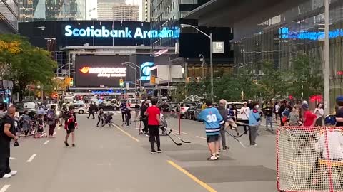 A street hockey game is being held in protest of vaccine and mask mandates in downtown Toronto