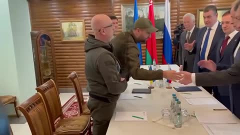 RUSSIAN AND UKRAINIAN HANDS SHAKING DURING BORDER MEETING