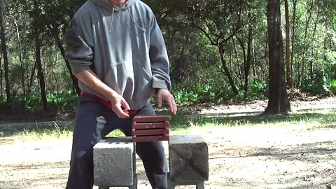 Purposefully Breaking The Top Brick Paver Of A Set Of 4 Brick Pavers With Spacers With A Palm Strike