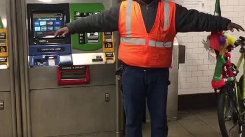 Man flaps his arms like a bird and makes bird noises in subway station