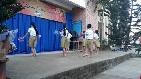 Elementary school students dance