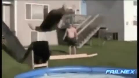 dude goes down slippery slide into pool- misses pool