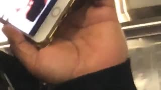 Guy pretending to be on phone but has video opened on his phone