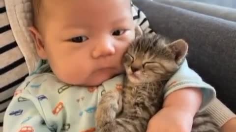 A cute baby have beautiful cat