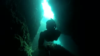 Diver risks one-breath swim through deep underwater tunnel