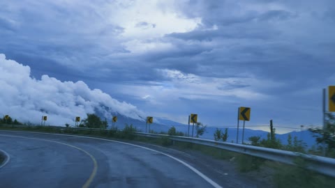 going-down-a-curved-highway-through-a-mountain-range-41576