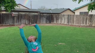 Kiddos Excited over Backyard Rainbow