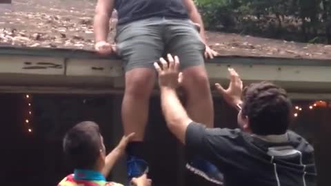 Black tank top guy cody tries to climb off roof and falls onto porch railing