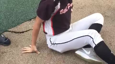 Softball girl slides down blue playground equipment and falls on face
