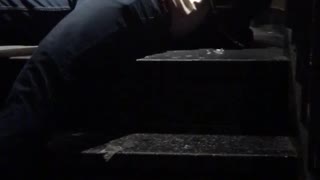 Guy in black jacket falling down stairs